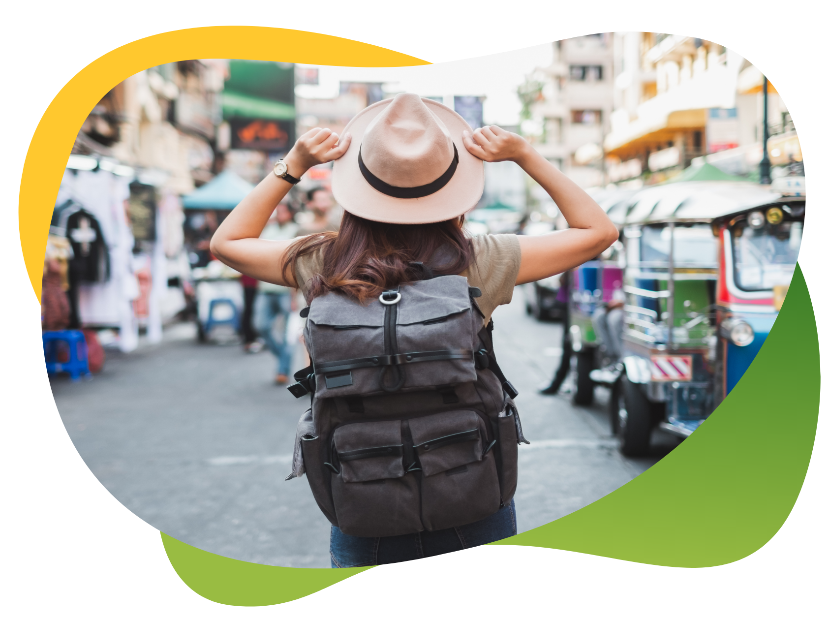 The back of a backpack tourist on the streets of Bangkok wearing a straw hat